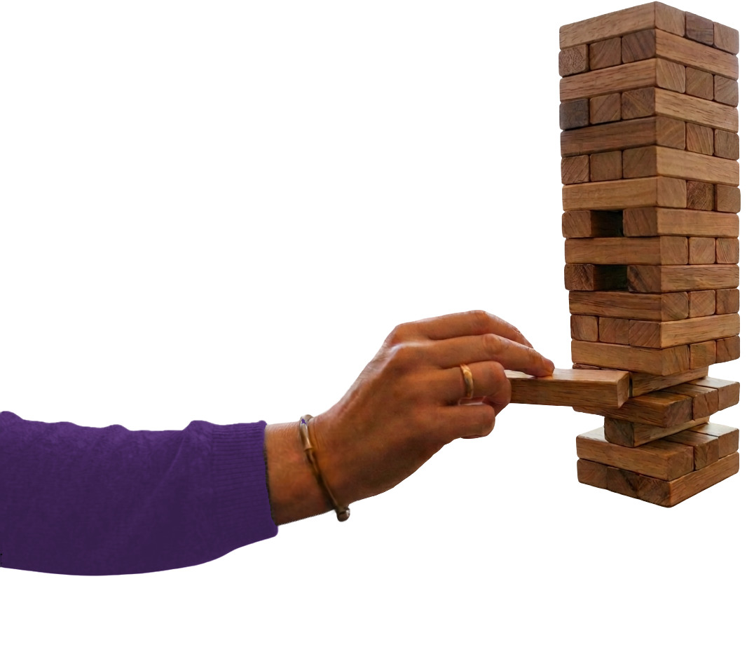 A hand slowly pulling a wooden block from a tall, teetering Jenga tower, a structure on the edge of collapse, like organizational systems built for a more stable era